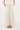 Crincle rok incl voering creme van Zusss; model draagt creme top en bruine sandalen