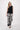 Black sleeveless linen top with tape detailing by Zusss, worn by a model.