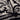V hals woven top borderprint | zwart / soft kit van Zusss, detail van print en stoftextuur.