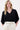 Model is wearing a black V-neck T-shirt with wide sleeves and Zusss embroidery by Zusss, featuring a loose fit and a casual look.