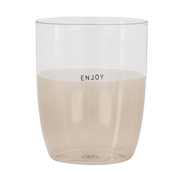 "Enjoy Sand" drinking glass by Zusss, with a clear upper section and a sand-colored base.