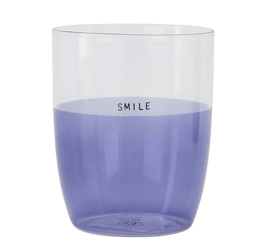Smile drinking glass in light blue by Zusss, a cylindrical glass featuring the word "SMILE."